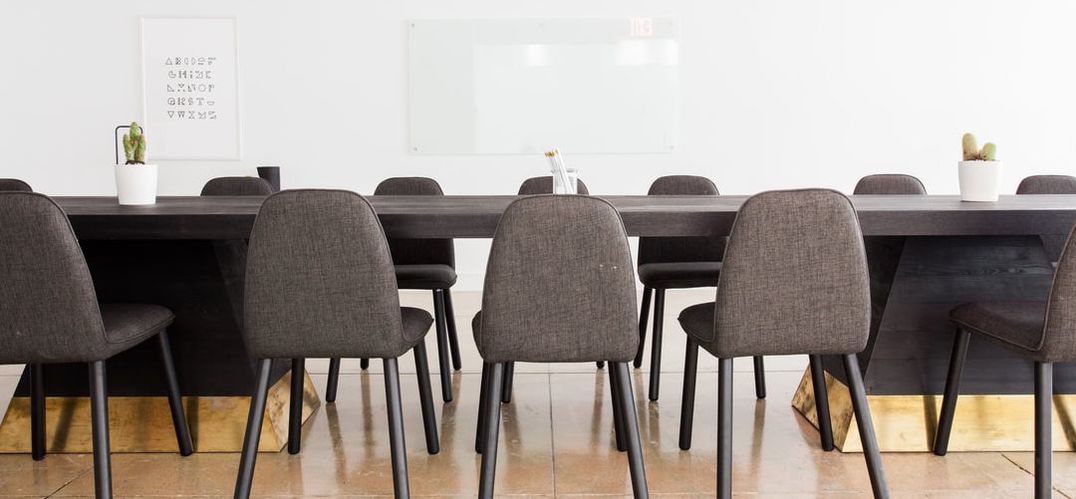 Grey empty chairs at conference table